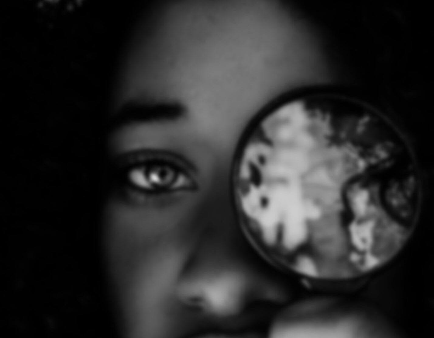 Close Up of a Person's Eyes, One Looking Through a Magnifying Glass